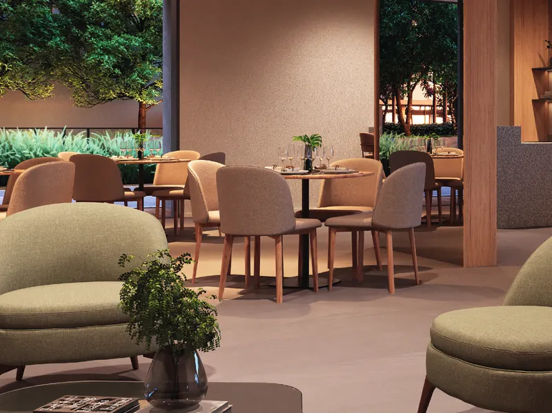 Espaço gourmet do Grand Quartier Rio2 com mesas, poltronas e vista para o jardim
