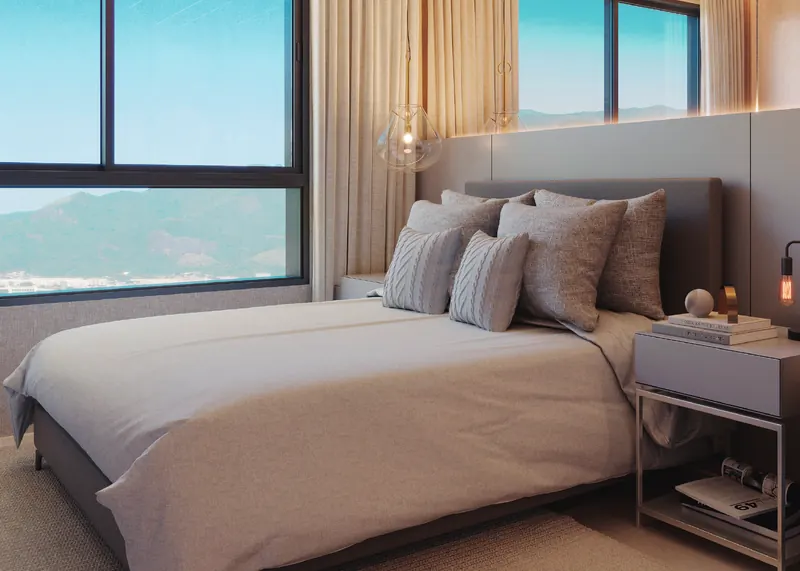 Suíte master de apartamento do Grand Quartier Rio2 com janelas amplas e vista para a Barra